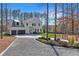 Stately home with a long driveway, lush landscaping, and two-car garage at 1455 Rucker Cir, Woodstock, GA 30188