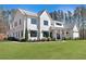 Charming two-story white home featuring black-framed windows, landscaped yard, and American flag at 1455 Rucker Cir, Woodstock, GA 30188