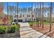 Elegant home with a circular driveway surrounded by a wooded landscape at 1455 Rucker Cir, Woodstock, GA 30188