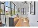 Hallway with large windows, wooden cabinet, and stylish decor at 1455 Rucker Cir, Woodstock, GA 30188