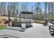 Outdoor hot tub with umbrella and seating area surrounded by trees at 1455 Rucker Cir, Woodstock, GA 30188
