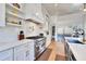 Modern kitchen with stainless steel appliances, white cabinets, and open shelving at 1455 Rucker Cir, Woodstock, GA 30188