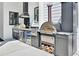 Outdoor kitchen with stainless steel grill, pizza oven, and storage at 1455 Rucker Cir, Woodstock, GA 30188