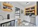 Stylish wet bar area features open shelving, modern appliances, and decorative tile flooring at 1455 Rucker Cir, Woodstock, GA 30188