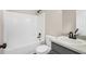 Bright bathroom featuring a shower-tub combo, black fixtures, and a modern sink with countertop at 201 Rustin Dr, Dallas, GA 30157