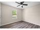 Cozy bedroom featuring a ceiling fan, a window and gray vinyl flooring at 201 Rustin Dr, Dallas, GA 30157