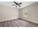 Cozy bedroom featuring a ceiling fan, a window and gray vinyl flooring at 201 Rustin Dr, Dallas, GA 30157