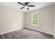 Cozy bedroom featuring a ceiling fan, a window and gray vinyl flooring at 201 Rustin Dr, Dallas, GA 30157