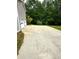 Long driveway leading to a home, with a two-car garage and ample parking space at 201 Rustin Dr, Dallas, GA 30157
