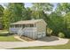 Charming home boasts a covered front porch, a lush landscaped yard, and a two-car garage at 201 Rustin Dr, Dallas, GA 30157