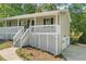 Charming home featuring a covered porch, white railings, and a freshly landscaped yard at 201 Rustin Dr, Dallas, GA 30157