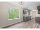 Bright kitchen with quartz counters, gray cabinets, stainless appliances, and wood laminate flooring at 201 Rustin Dr, Dallas, GA 30157