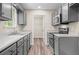 Updated kitchen showcasing stainless steel appliances, quartz counters, and gray cabinetry at 201 Rustin Dr, Dallas, GA 30157