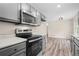 Modern kitchen boasting gray cabinets, quartz countertops, and stainless steel appliances at 201 Rustin Dr, Dallas, GA 30157