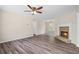 Inviting living room featuring a cozy stone fireplace and durable wood laminate flooring at 201 Rustin Dr, Dallas, GA 30157