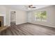 Bright living room with wood laminate flooring, a ceiling fan, and ample natural light at 201 Rustin Dr, Dallas, GA 30157