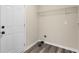 The mud room has gray vinyl flooring, a back door, a storage shelf and a dryer vent at 201 Rustin Dr, Dallas, GA 30157