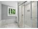 Bathroom showcasing glass enclosed shower with marble tiling and stone floor at 3031 San Jose Dr, Decatur, GA 30032