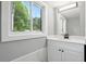 Bathroom featuring white cabinets and marble counters with window view at 3031 San Jose Dr, Decatur, GA 30032