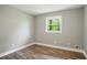 An empty bedroom with a window providing natural light, enhanced by wood flooring at 3031 San Jose Dr, Decatur, GA 30032