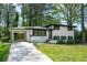 Beautiful home with a white painted brick exterior, carport and well-maintained lawn at 3031 San Jose Dr, Decatur, GA 30032