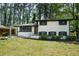 Charming, renovated home featuring a classic white painted brick exterior and mature trees at 3031 San Jose Dr, Decatur, GA 30032
