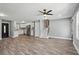 Open-concept living area with modern kitchen featuring white cabinets and hard surface flooring at 3031 San Jose Dr, Decatur, GA 30032