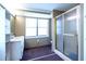 Bathroom featuring a walk-in shower, a large window, and a vanity with ample storage at 1098 Cown Rd, Villa Rica, GA 30180