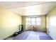 Bedroom featuring carpeted floors, a small bay window bringing in light, and neutral colored walls at 1098 Cown Rd, Villa Rica, GA 30180
