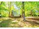 Unique A-frame cabin nestled among mature trees on a verdant lawn at 1098 Cown Rd, Villa Rica, GA 30180