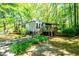 Charming home nestled among lush greenery, featuring a covered porch and inviting entrance at 1098 Cown Rd, Villa Rica, GA 30180