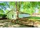 Exterior of a shed located on a property that is landscaped with lush green grass and trees at 1098 Cown Rd, Villa Rica, GA 30180