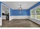 Bright dining room featuring new wood floors, wainscoting, and an eye-catching modern chandelier at 5185 Twin Oak Ne Dr, Woodstock, GA 30188