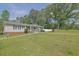 Lovely single story home on expansive yard with mature trees, manicured lawn, and welcoming curb appeal at 5185 Twin Oak Ne Dr, Woodstock, GA 30188