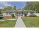 Charming single-story home features a covered porch with swing, classic siding, and lush landscaping at 5185 Twin Oak Ne Dr, Woodstock, GA 30188