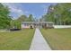 Inviting home featuring classic siding, a covered porch with a swing, and a well-manicured lawn at 5185 Twin Oak Ne Dr, Woodstock, GA 30188
