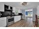 Updated kitchen with stainless steel appliances and black countertops at 5185 Twin Oak Ne Dr, Woodstock, GA 30188