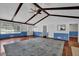 Open living room featuring hardwood floors, wooden ceiling beams and stylish ceiling fan at 5185 Twin Oak Ne Dr, Woodstock, GA 30188