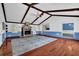 Large living space features hardwood floors, a cozy fireplace, and a vaulted ceiling with exposed beams at 5185 Twin Oak Ne Dr, Woodstock, GA 30188