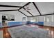 Open-concept living room showcasing hardwood floors, a fireplace, beamed ceilings, and great natural light at 5185 Twin Oak Ne Dr, Woodstock, GA 30188