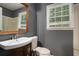 Bathroom with a single vanity, toilet, and a window that brings in light by the bathtub at 2412 Forrest Park Se Rd, Atlanta, GA 30315