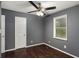 Bedroom featuring hardwood floors, ceiling fan, and a door with one window at 2412 Forrest Park Se Rd, Atlanta, GA 30315