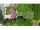 Aerial view of a private home on a wooded lot with a concrete patio, walkway and driveway at 2502 Kerry Ne Ct, Marietta, GA 30066