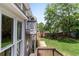 Exterior shot of the house showing the backyard, including a deck, balcony, and lush greenery at 2502 Kerry Ne Ct, Marietta, GA 30066