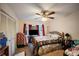 Bright bedroom features a window with red curtains, ceiling fan and a bed with a decorative quilt at 2502 Kerry Ne Ct, Marietta, GA 30066