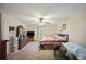 Bedroom featuring neutral walls, ceiling fan, a comfortable bed, dresser and an adjacent sitting area at 2502 Kerry Ne Ct, Marietta, GA 30066