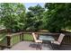 Relaxing deck area with a glass table and chairs, perfect for outdoor dining and enjoying the view at 2502 Kerry Ne Ct, Marietta, GA 30066
