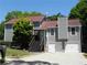 Charming gray home with a red roof, a two-car garage, and a welcoming front entrance with stairs at 2502 Kerry Ne Ct, Marietta, GA 30066
