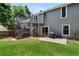 Back exterior of home showcasing a deck, patio, and well-maintained yard with mature landscaping at 2502 Kerry Ne Ct, Marietta, GA 30066