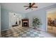 Inviting living room with a cozy fireplace, plant stand and a unique checkered tile floor pattern at 2502 Kerry Ne Ct, Marietta, GA 30066